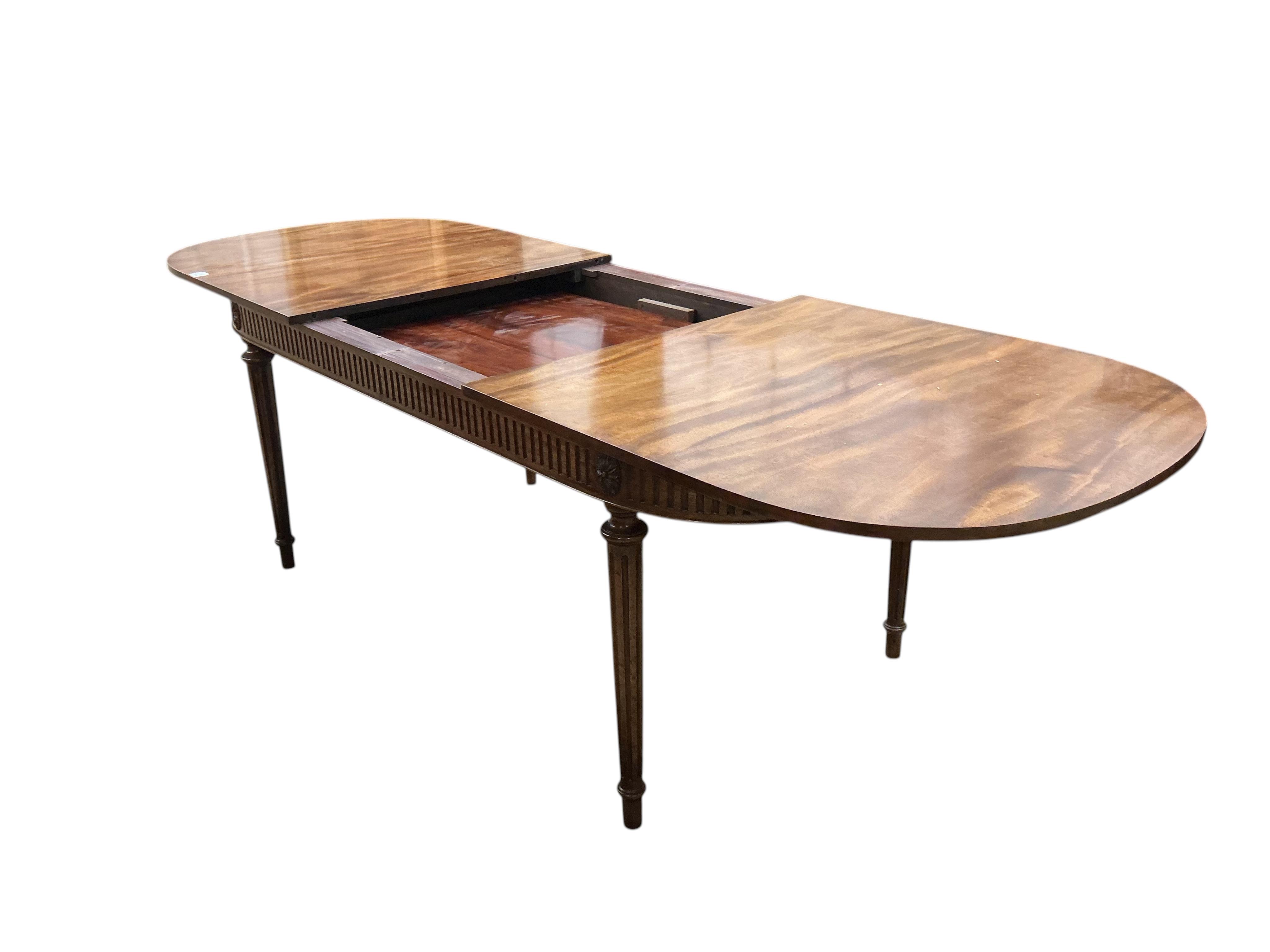 A reproduction Sheraton style mahogany extending dining table, 260cm extended, one spare leaf, width 91cm, height 76cm